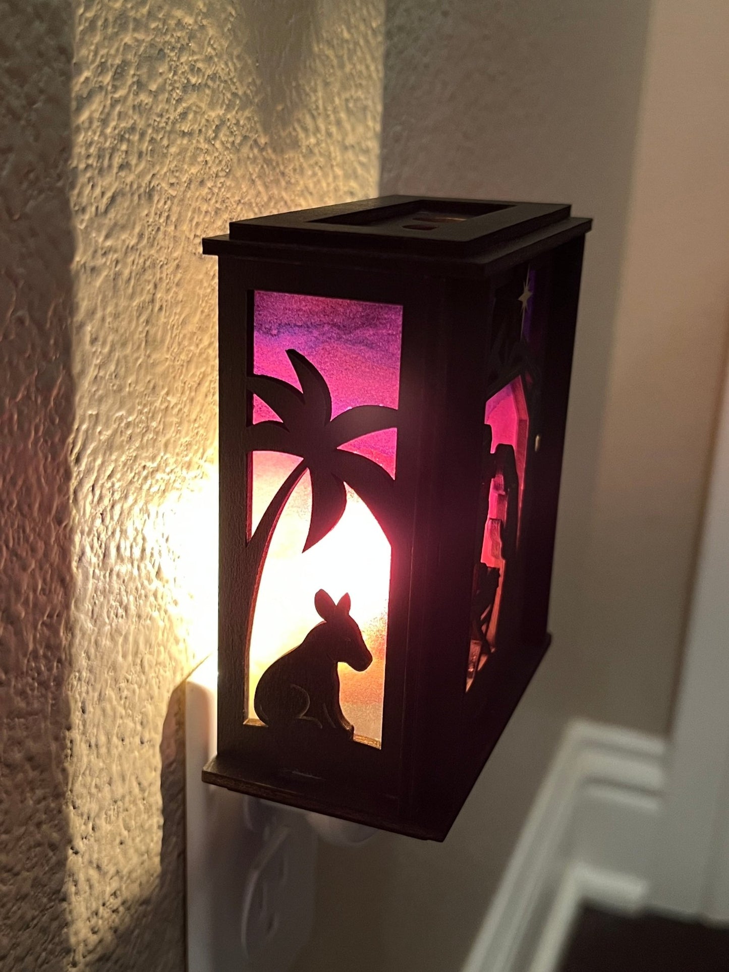 Black wood and multicolor acrylic Christmas Nativity Lantern Nightlight lit in hall.