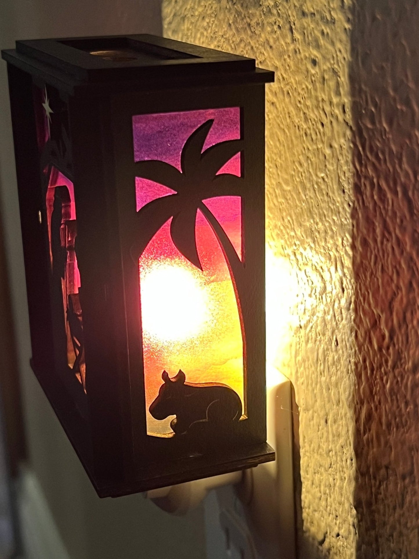 Black wood and multicolor acrylic Christmas Nativity Lantern Nightlight lit left side view in hall.