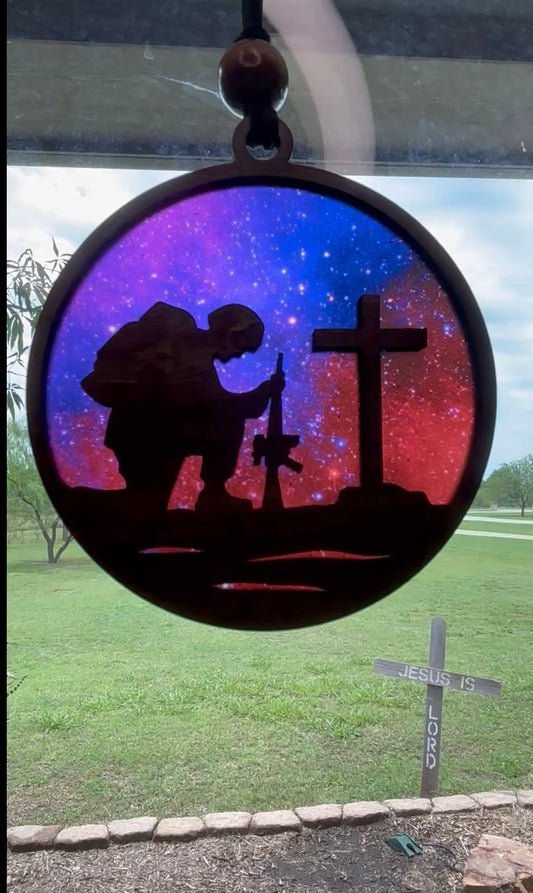 Multicolor suncatcher with walnut-stained wood and acrylic, showcasing a fallen soldier theme in sunlight.