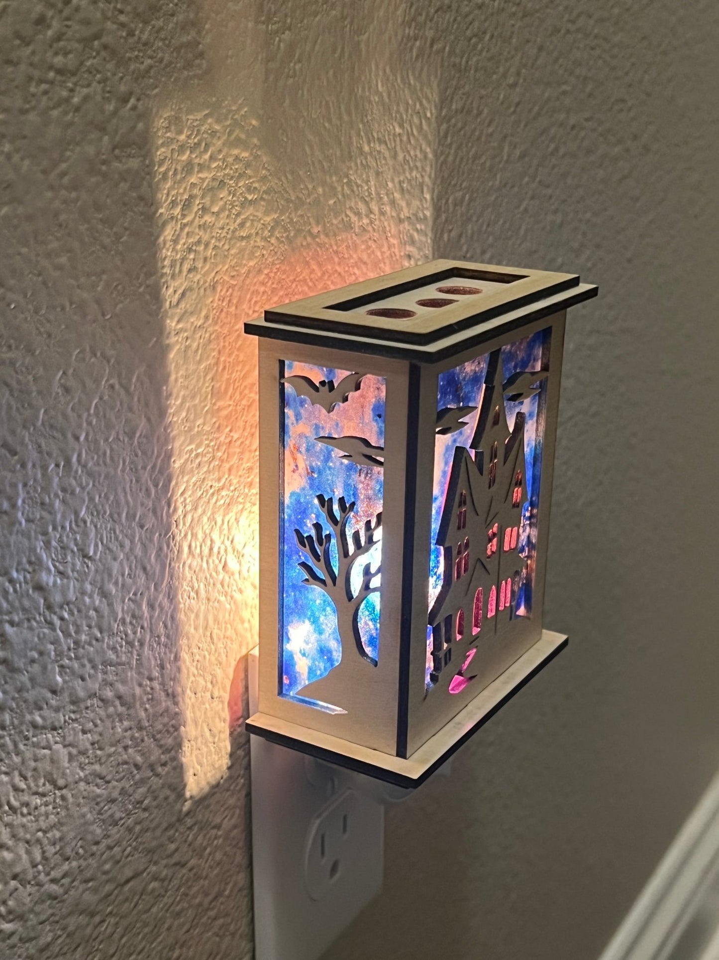 Halloween Haunted House Lantern Nightlight made from wood and acrylic, showcasing rustic charm and multicolor glow lighted in a lit hallway with right view.