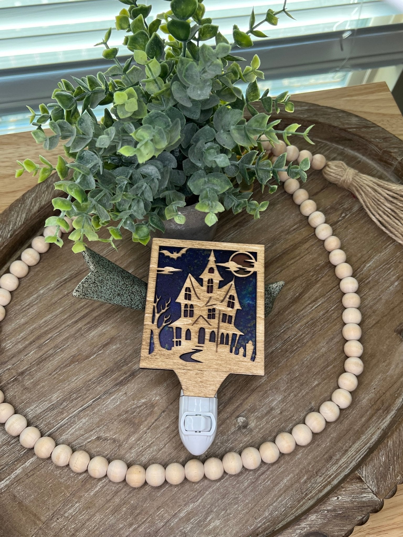 Haunted House Nightlight made of wood and acrylic, golden oak stained, rustic decor, front facing up.