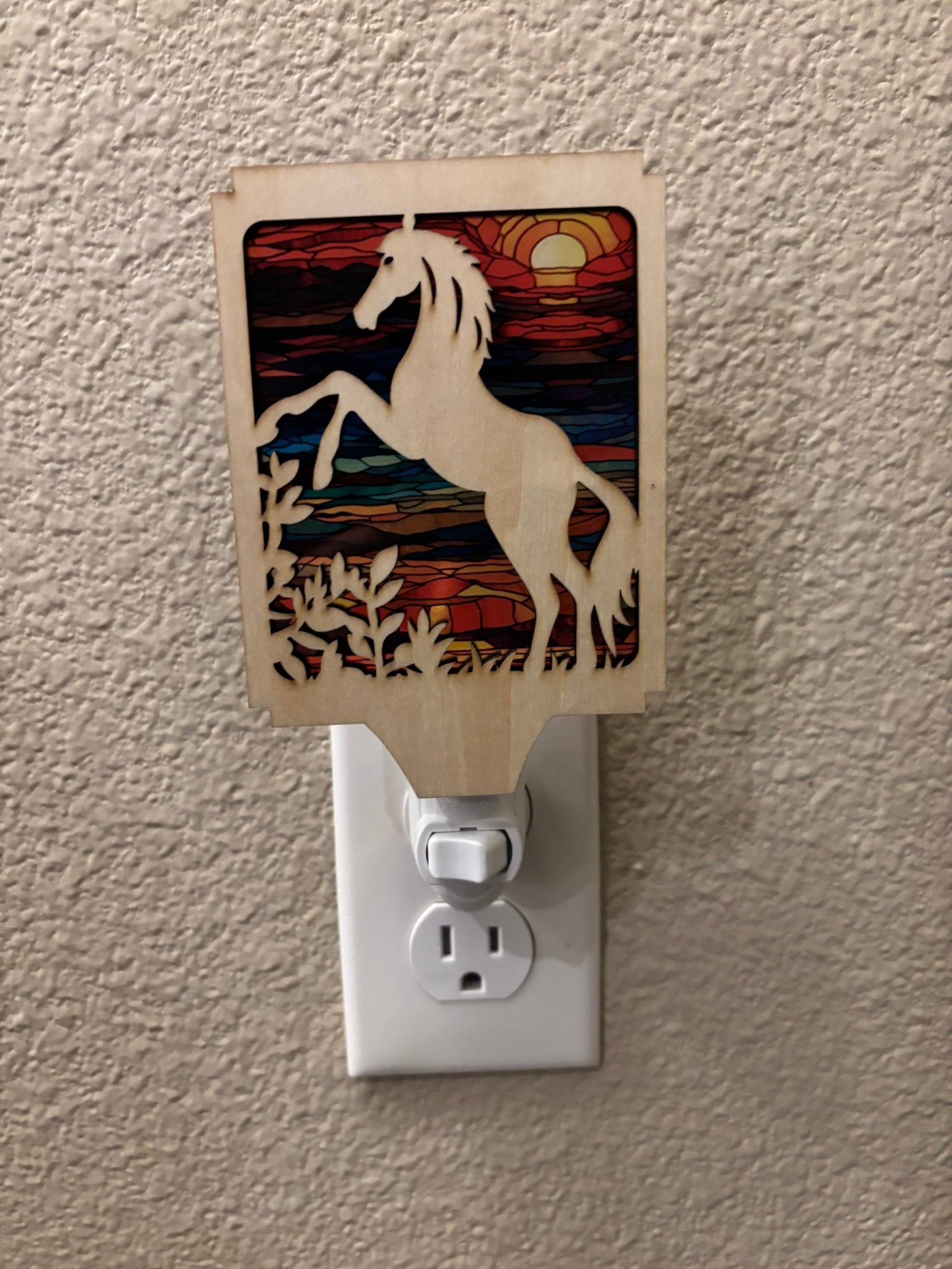 A rustic horse nightlight made of wood and acrylic with a stained glass effect.