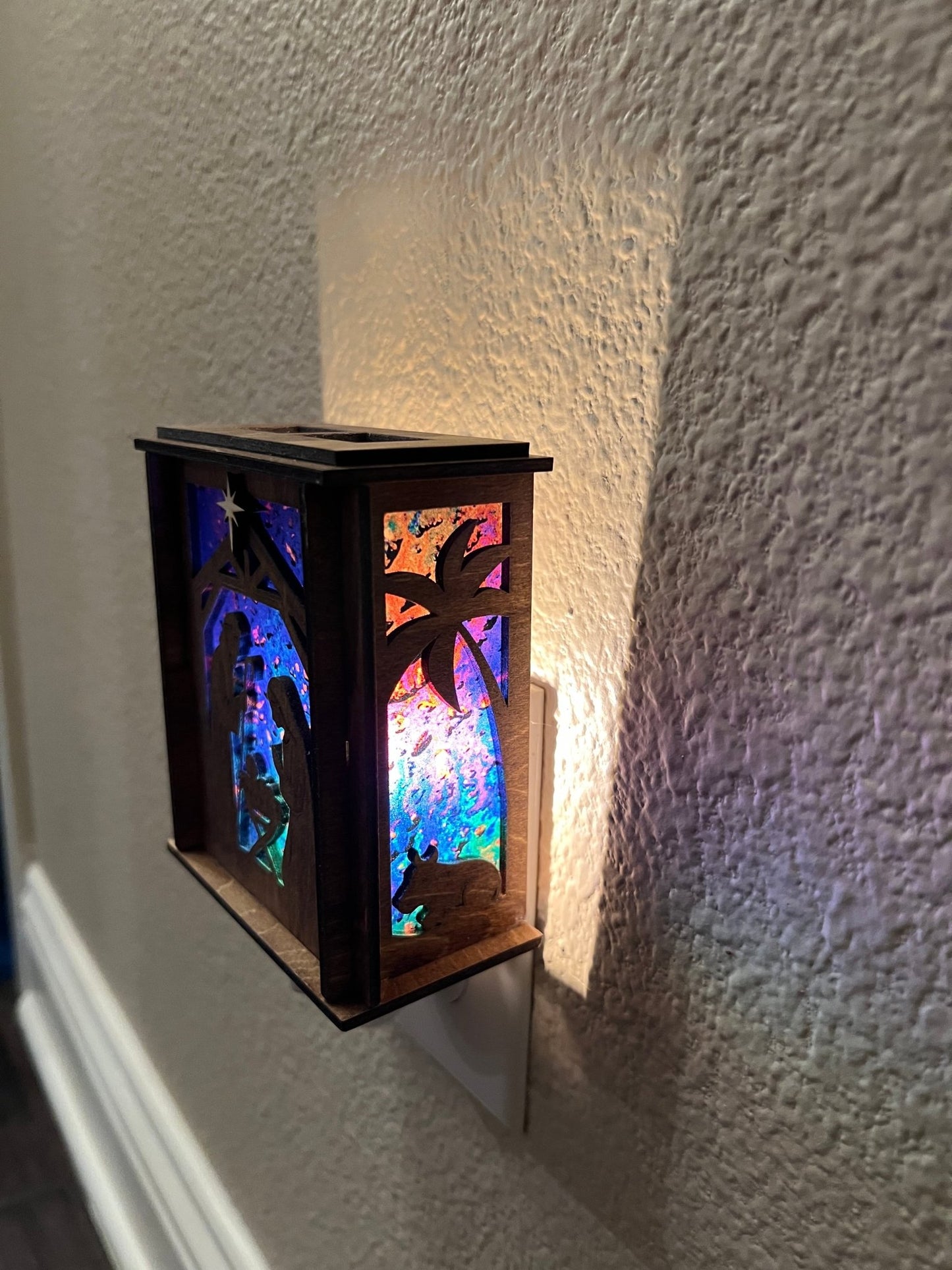 Golden oak stained wooden and acrylic nativity nightlight with rustic charm right view plugged in lit.