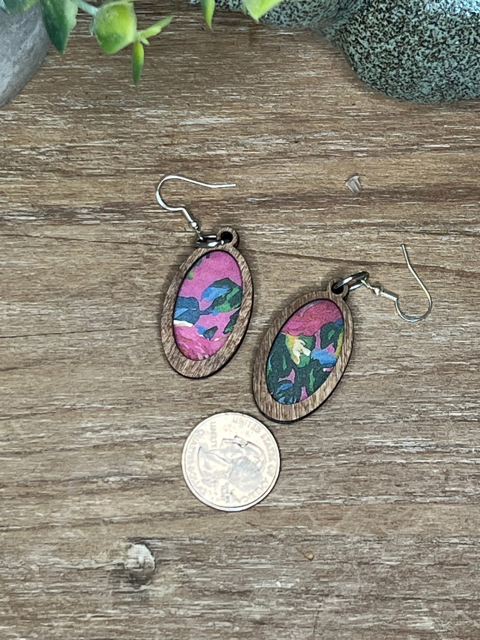 Pink floral suncatcher earrings with wood and acrylic materials, rustic style.