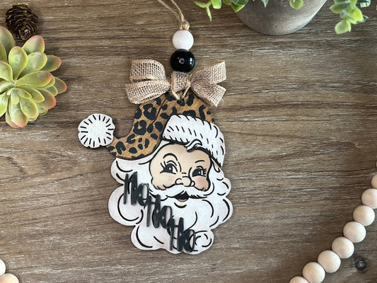 Vintage Santa Christmas Ornament with a leopard hat, made of natural wood - zoomed in.