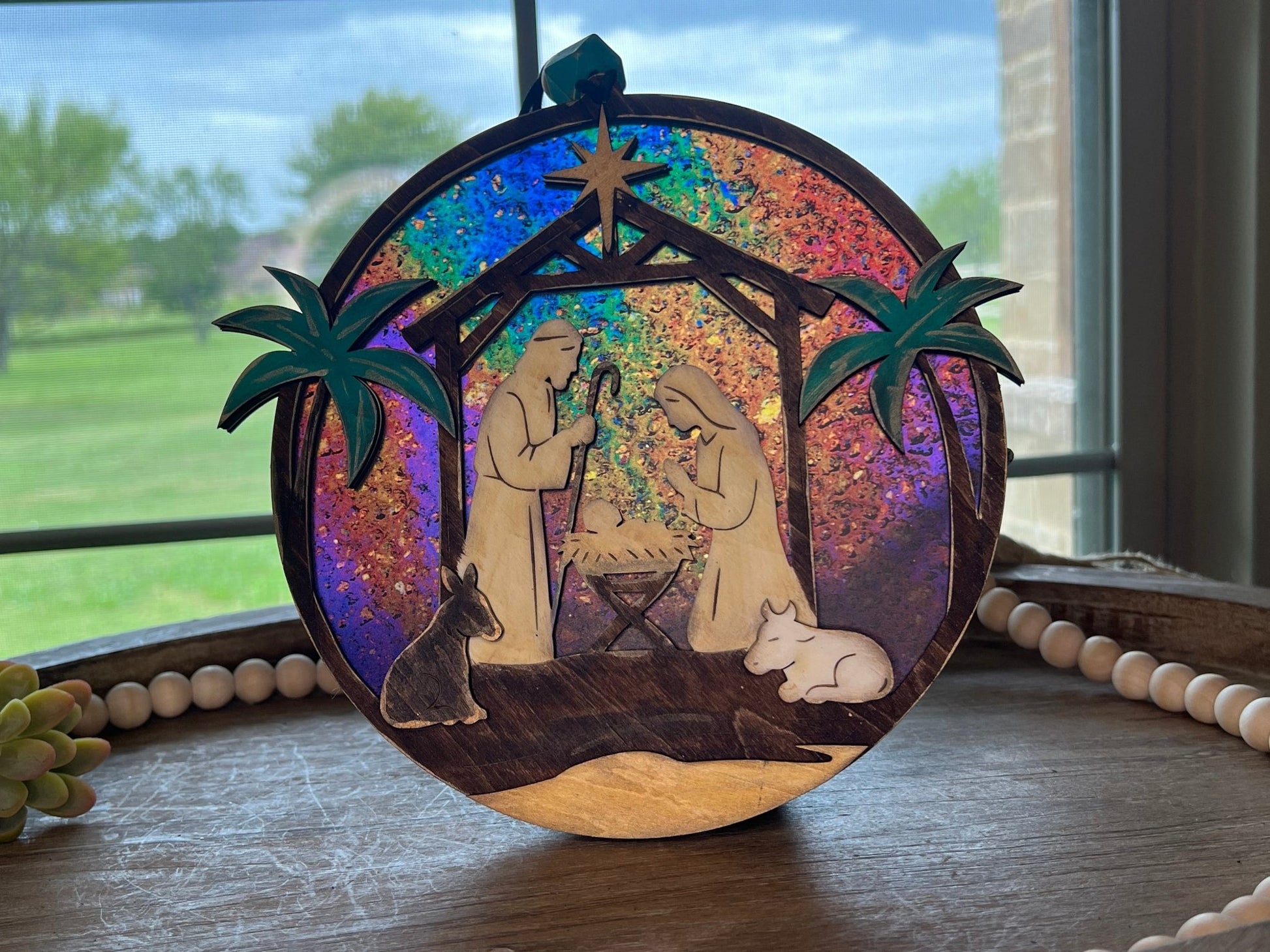Haunted House Lantern Nightlight with stained glass effect in golden oak wood, perfect for rustic decor - on a tray in natural light.